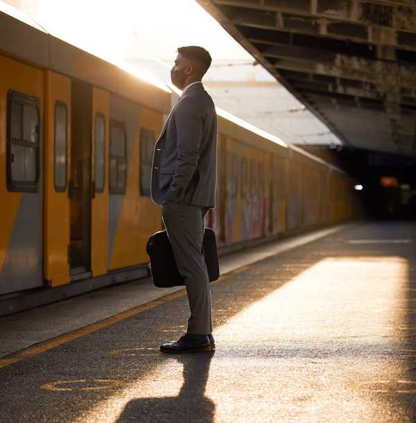 man – A man standing – waiting for train